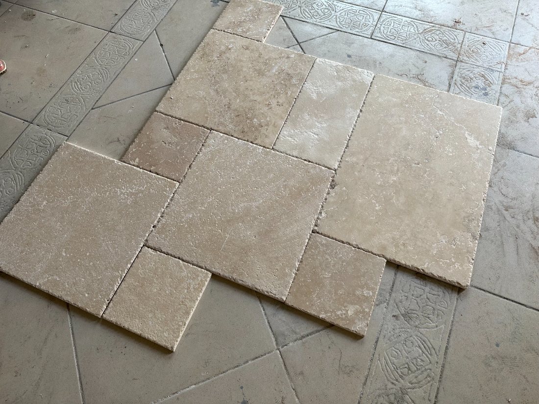 Natural travertine tiles laid out before fixing