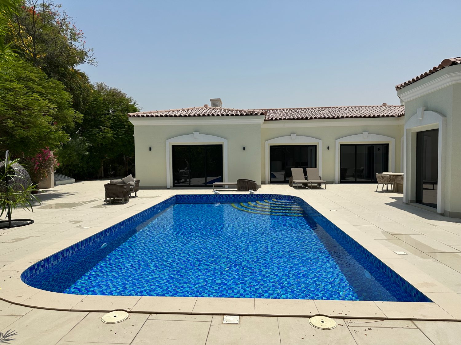 Pool deck with water feature and dolphin spouts
