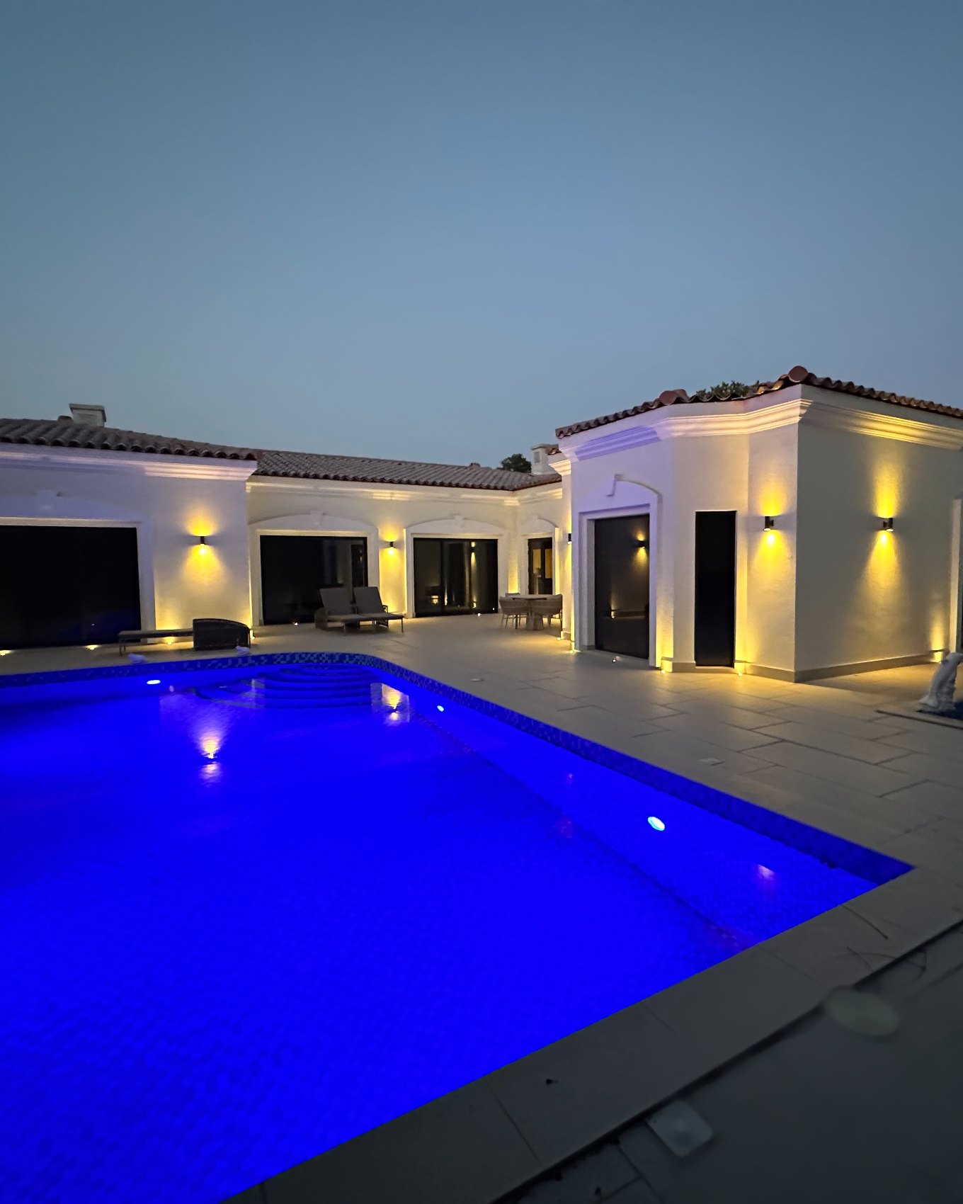 Expert Fitouts — renovated villa and pool in Green Community, Dubai, lit at night